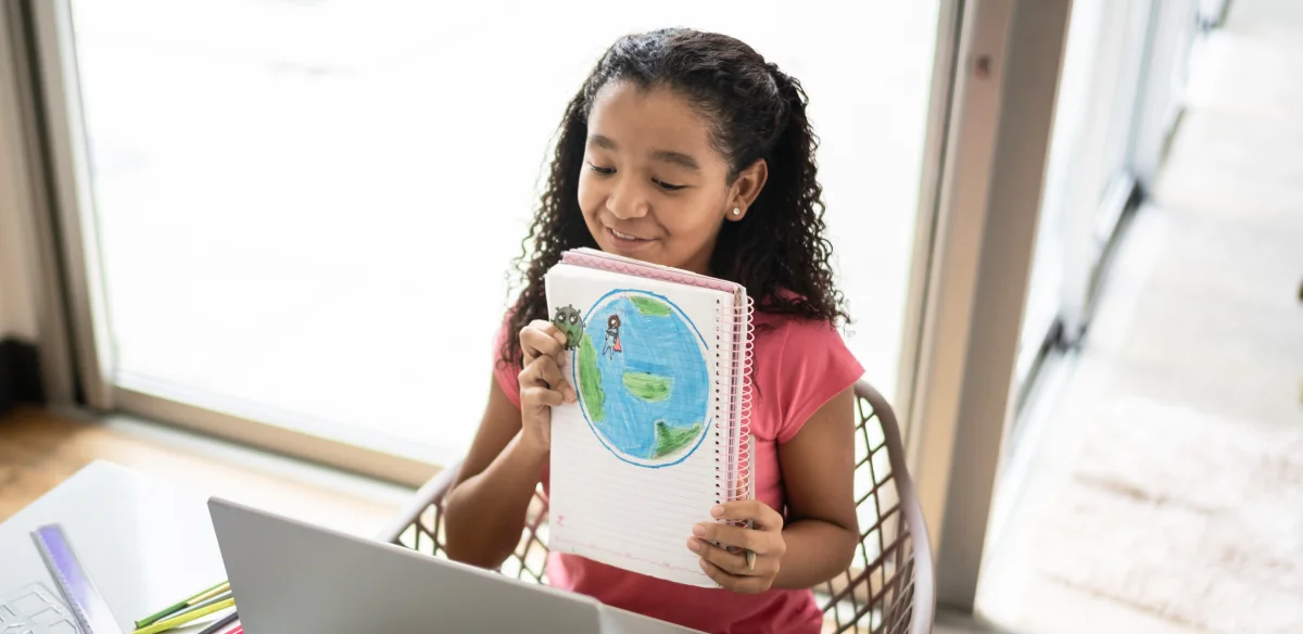 girl with notebook in her hands showing a map