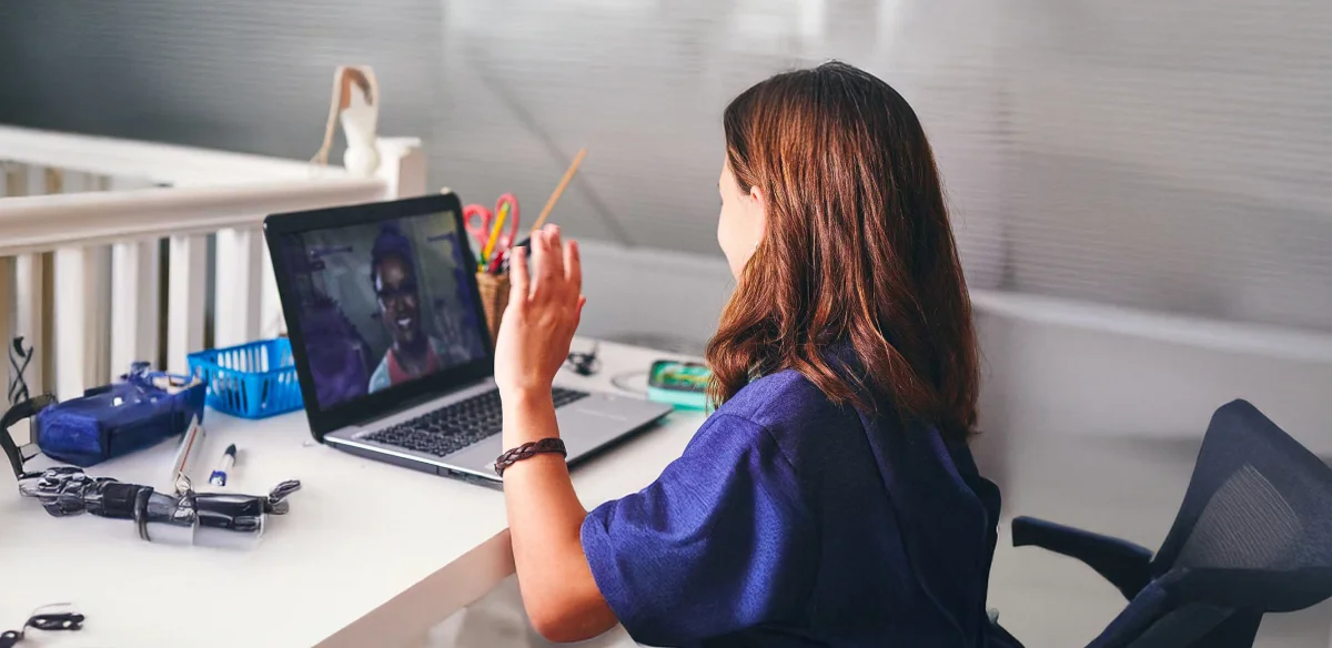 Student waiving to her online class